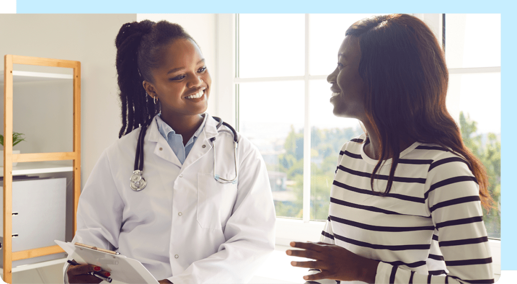Image of young adult patient and doctor having a conversation.
