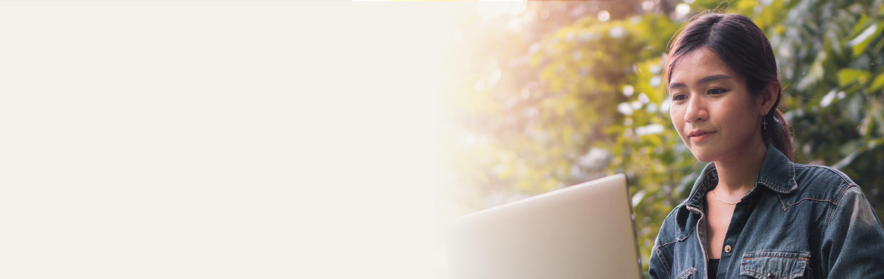 Image of young adult reading a laptop screen.